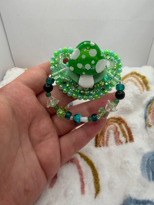 Green Mushie Shaker Paci (Glass Bead Handle)